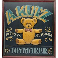 Kutz Toymaker sign with central low relief decoration of a teddy bear, H76cm L71cm