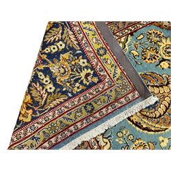 Central Persian Qum pale blue ground rug, the field decorated with stylised plant motifs surrounded by trailing foliate vine patterns in a symmetrical format, the multi-band guarded indigo border decorated with repeating flowerheads 