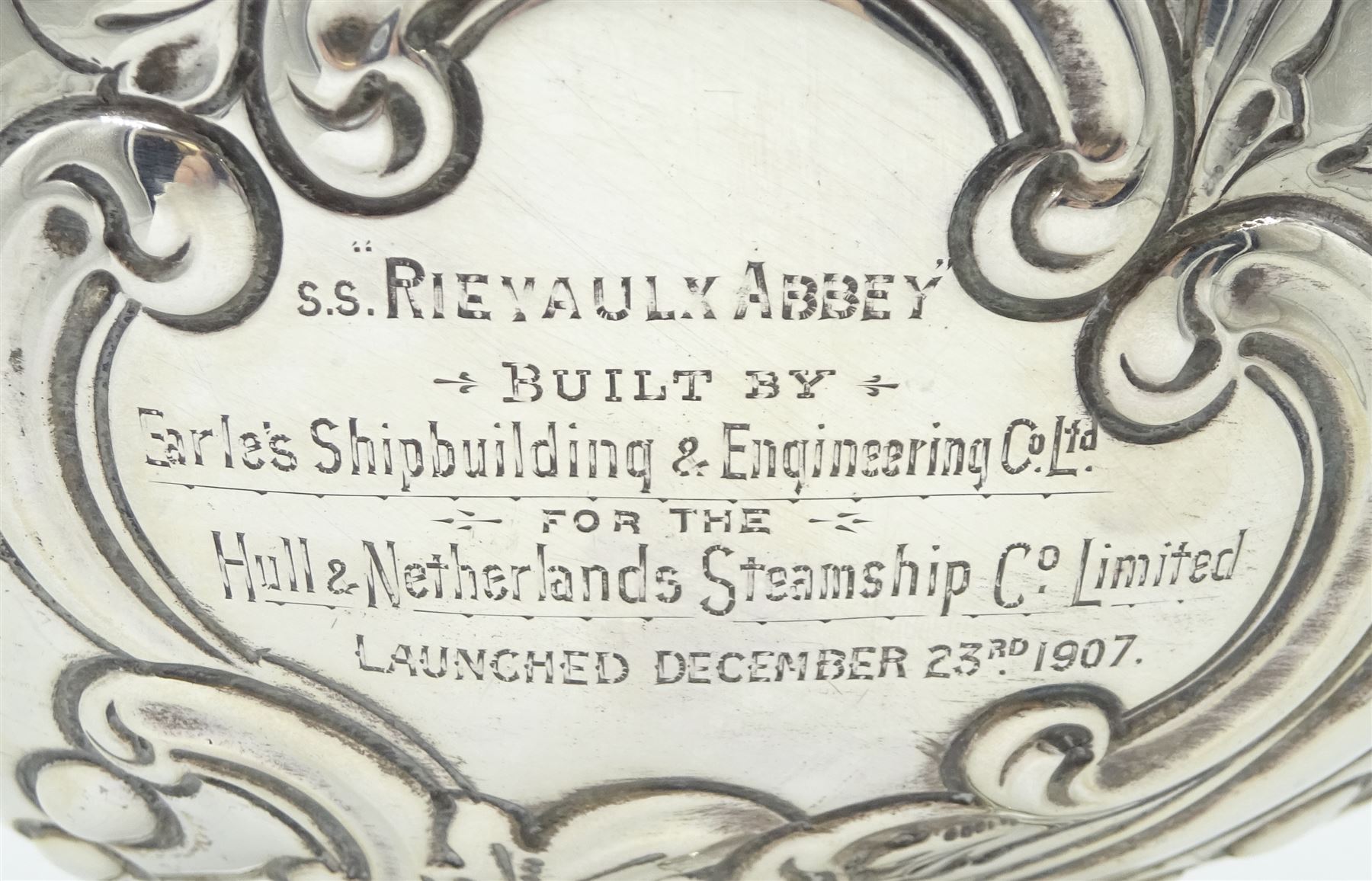 Edwardian silver rose bowl, the part fluted bowl embossed with acanthus leaves, flower heads and C scrolls and personally engraving 'S.S Rievaulx Abbey - Built By - Earle's Shipbuilding & Engineering Co Ltd - For The - Hull & Netherlands Steamship Co. Limited Launched December 23rd 1907', upon a spreading circular foot, hallmarked F Boyton & Co, London 1905, H14.5cm, D20.5cm, approximate weight 17.34 ozt (539.6 grams)