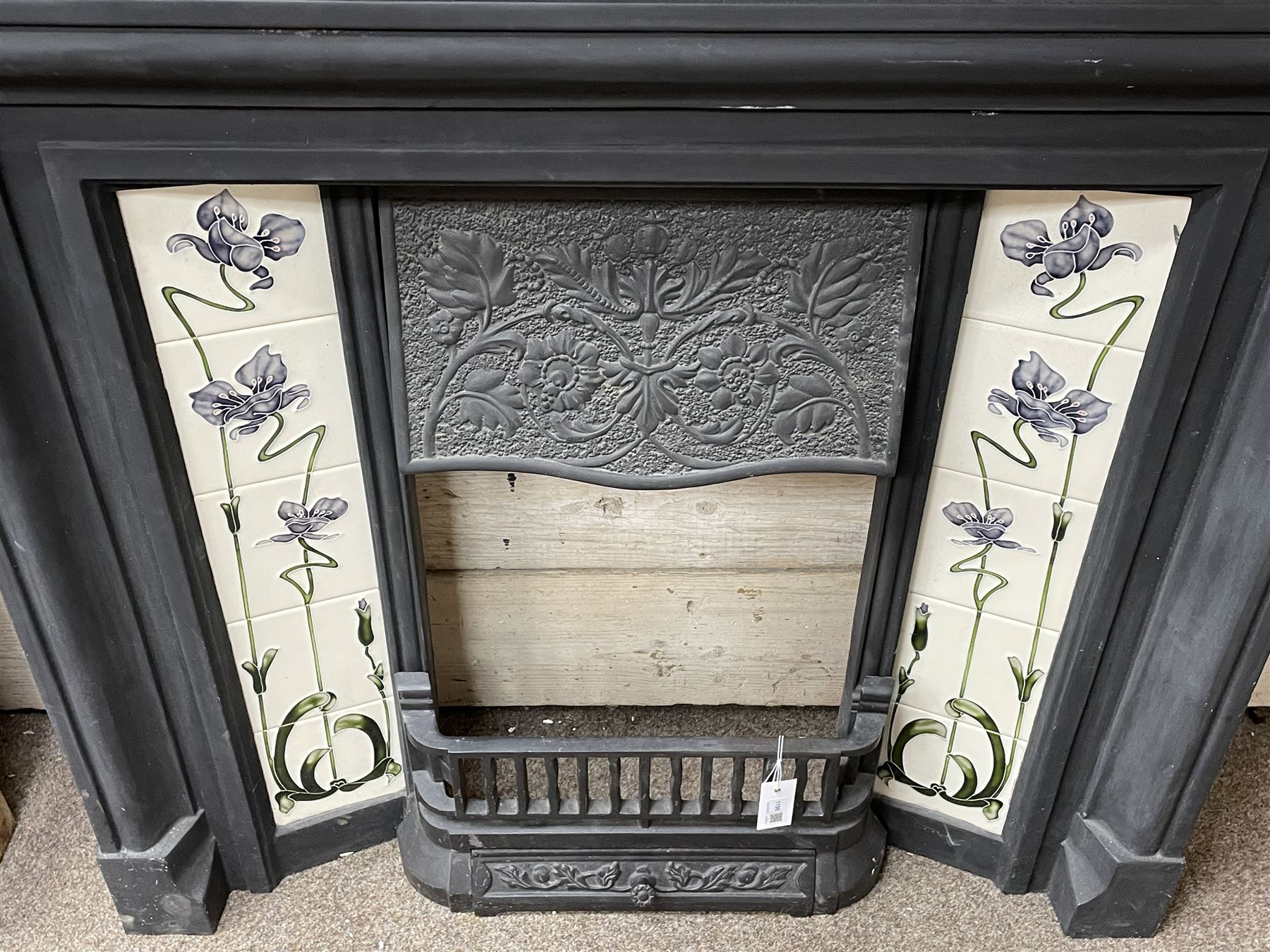 The Gallery Collection Fireplaces - 'Edwardian' cast iron fireplace, the hood decorated with interlacing floral design, with Art Nouveau inspired upright tiles