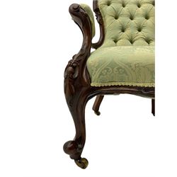 Victorian walnut farmed open armchair, the cresting rail relief carved with scrolls and central cartouche, upholstered seat and arms, with buttoned back in pale green foliate pattern fabric, cabriole supports