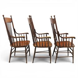 Set of three 19th century ash and elm spindle back Windsor armchairs, arched top rails above fan-shaped spindle backs, curved arms with turned supports, shaped saddle seats, on turned legs joined by H-stretchers