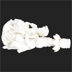 Pair of 19th century Meissen style Blanc de Chine figural candlesticks, each depicting children gathering flowers, with spurious mark beneath, H21cm