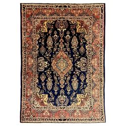 Persian Herati design indigo and red ground carpet, decorated with floral motifs, arched border