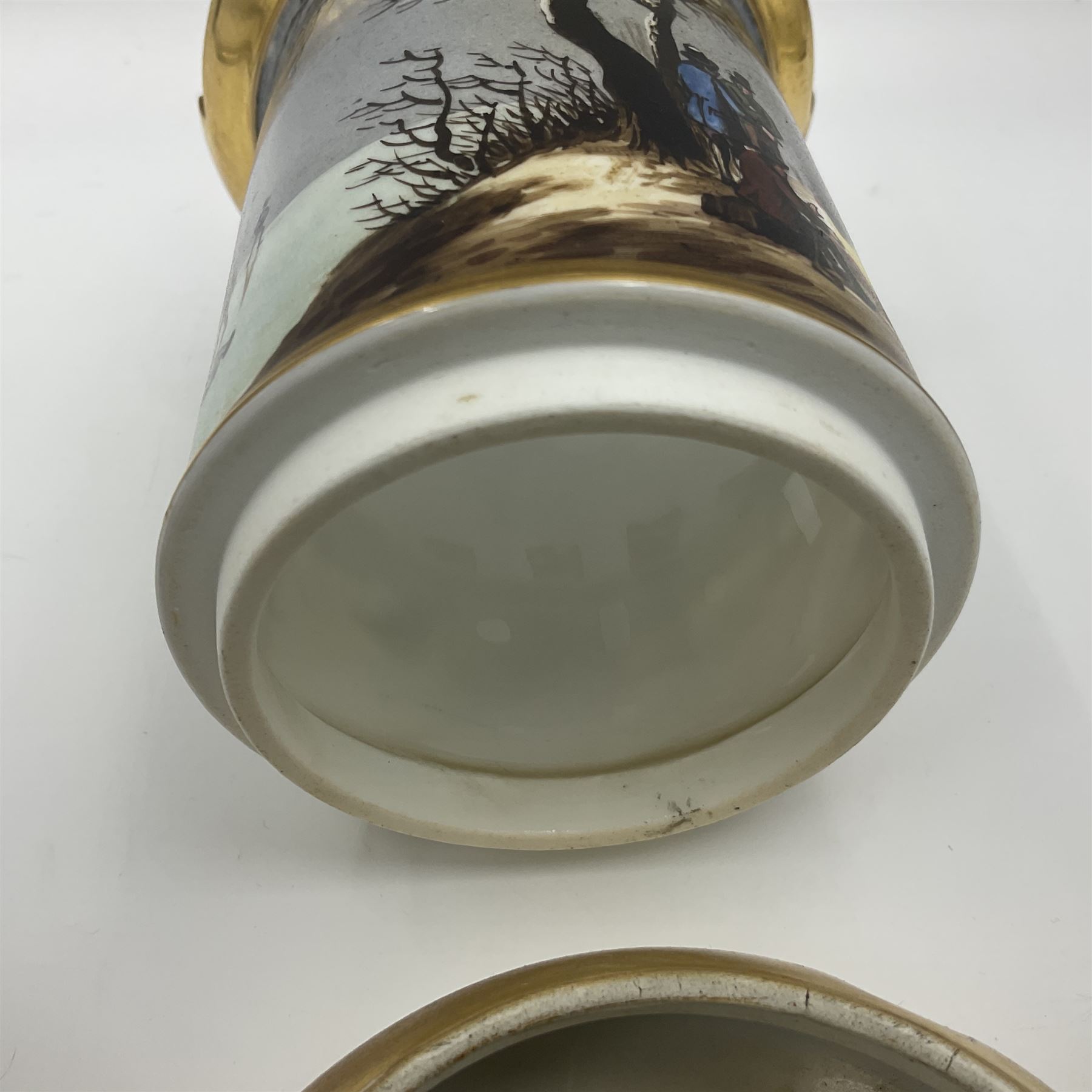 Two 19th century continental teapots and warmers, each teapot upon a cylindrical warming base in the form of a castle, hand printed with winter landscapes, largest H22cm 