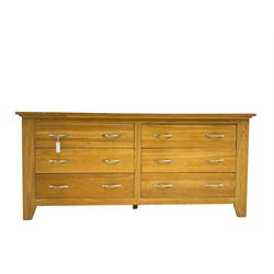 Contemporary wide oak straight-front chest, fitted with a bank of six drawers with chrome handles, on tapered feet