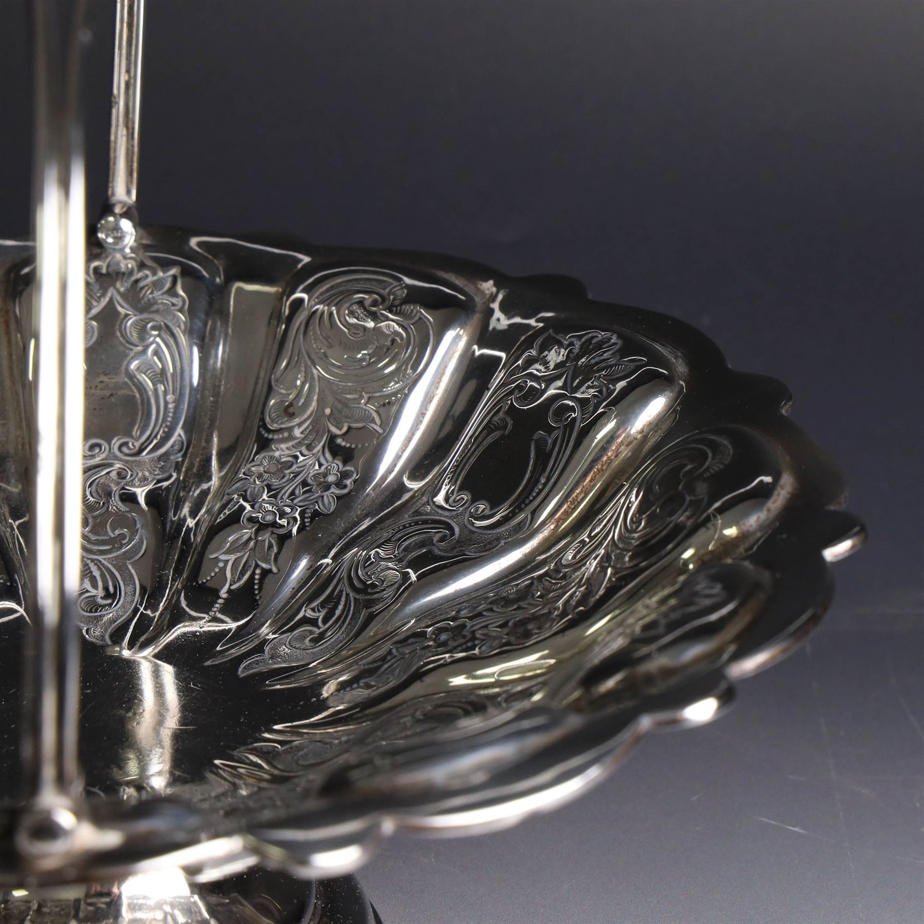 Edwardian silver swing handled basket, of circular form with shaped rim and engraved floral and foliate decoration, with know design swing handle and upon circular stepped pedestal, hallmarked J Sherwood & Sons, Birmingham 1901, H9cm, D22cm