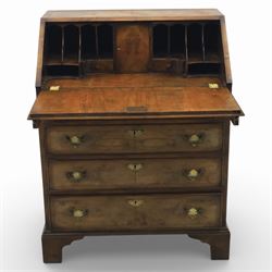 19th century walnut bureau of small proportions, the sloping fall enclosing a fitted interior with shaped pigeonholes and small drawers, above four long graduated drawers with feather banded walnut veneers, fitted with brass swan neck handles and escutcheons, raised on shaped bracket feet