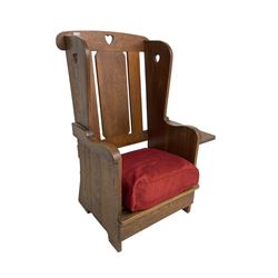 Arts and Crafts design oak reading wingback armchair, high back with pierced heart design, drop-leaf side table to one arm