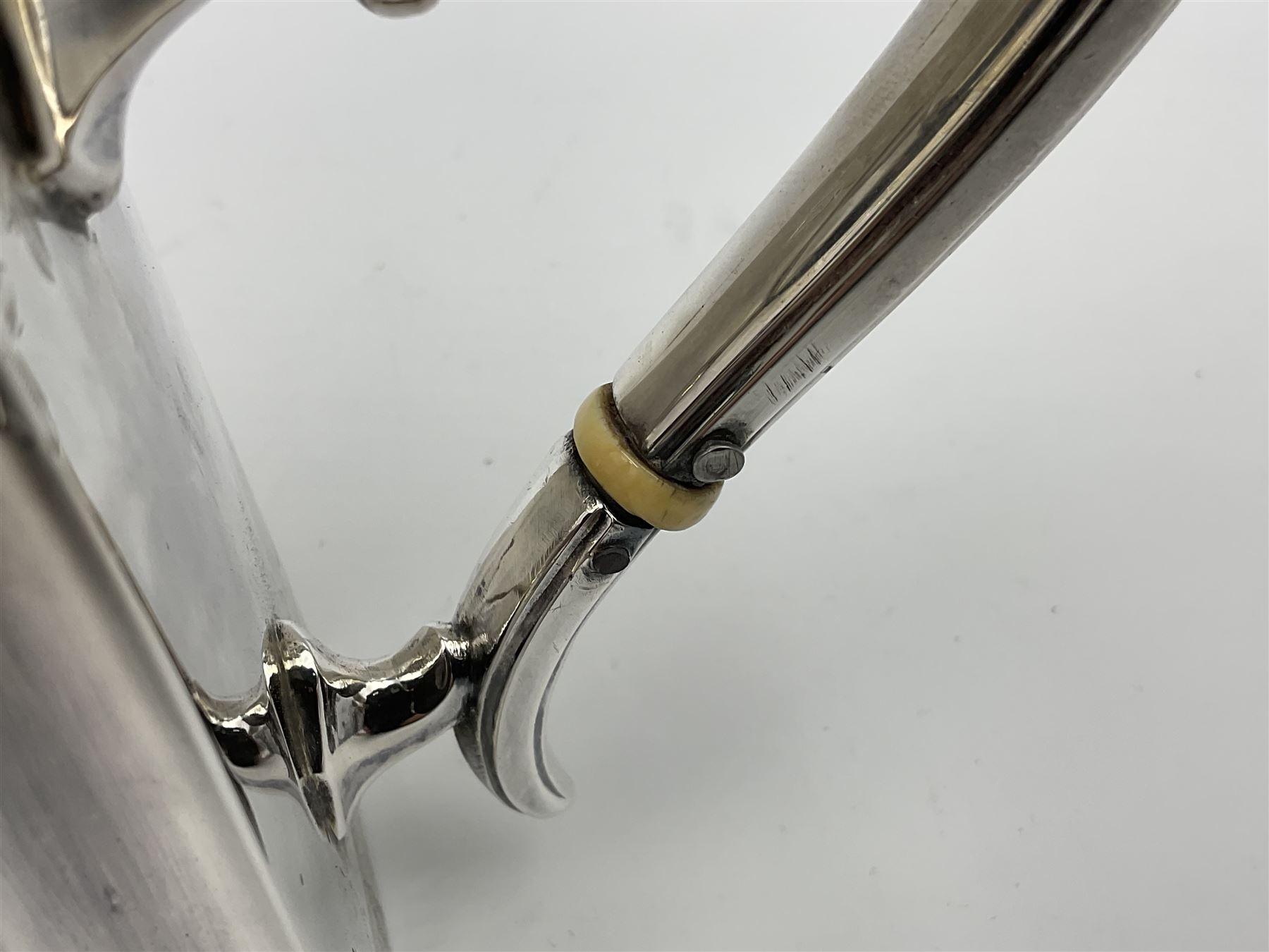 Victorian three-piece silver tea service, comprising teapot, twin handled open sucrier and milk jug, of oval form with shaped rim and C handles, each engraved with crests and bands of strapwork decoration, the milk jug and sucrier with gilt interiors, hallmarked Josiah Williams & Co, Exeter 1881, the teapot with ivory insulators and finial, all contained with a tooled leather, blue silk and velvet lined fitted case, retailed by West & Sun, Dublin 
This item has been registered for sale under Section 10 of the APHA Ivory Act