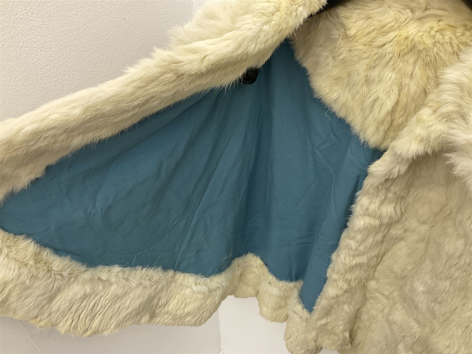 Brown mid length musquash fur coat by National Fur Company together with white rabbit cape