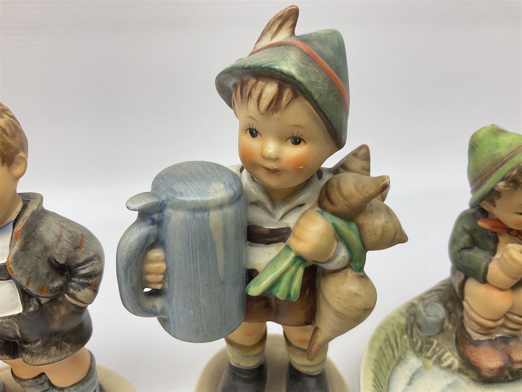 Twenty six Hummel figures by Goebel, to include Fire Fighter, Band Leader and Spring Sowing