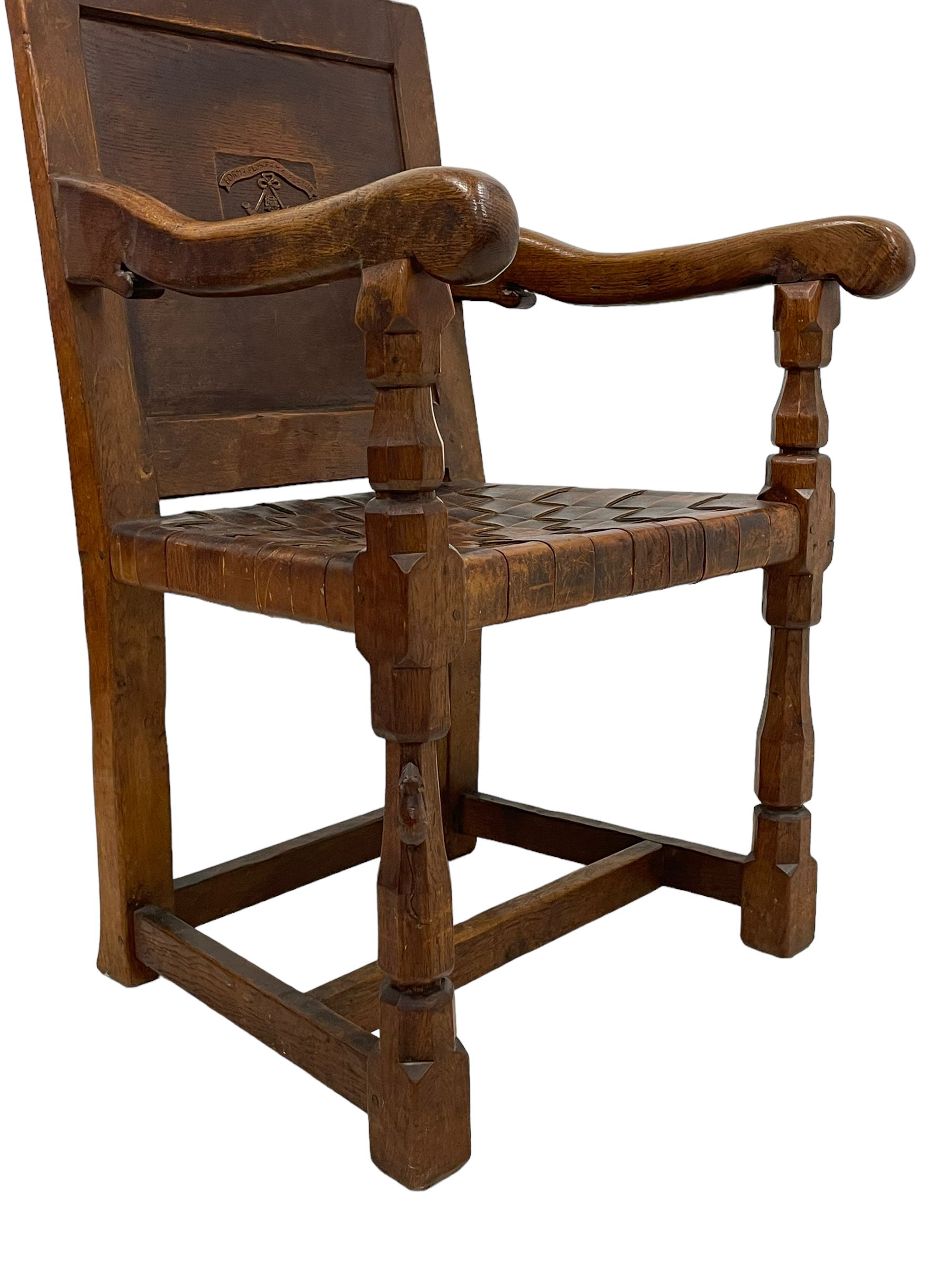 Mouseman - circa. 1930s set of six (4+2) oak dining chairs, panelled back carved with the Bagshawe family crest, the moto 'Forma Flos Fama Flatus' over an arm grasping a bugle-horn with ribbon tie and Yorkshire rose motif, adzed frame, leather lattice strap seat, on octagonal supports united by stretchers, two carvers and four side chairs, each carved with mouse signature, by Robert Thompson of Kilburn 

Provenance: Owned since manufacture by the Bagshawe family, descendants of the Staithes Group Artist Joseph Richard Bagshawe RBA (1870-1909).
