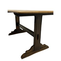 Ercol oak dining table, rectangular end supports joined by stretcher on shaped sledge feet