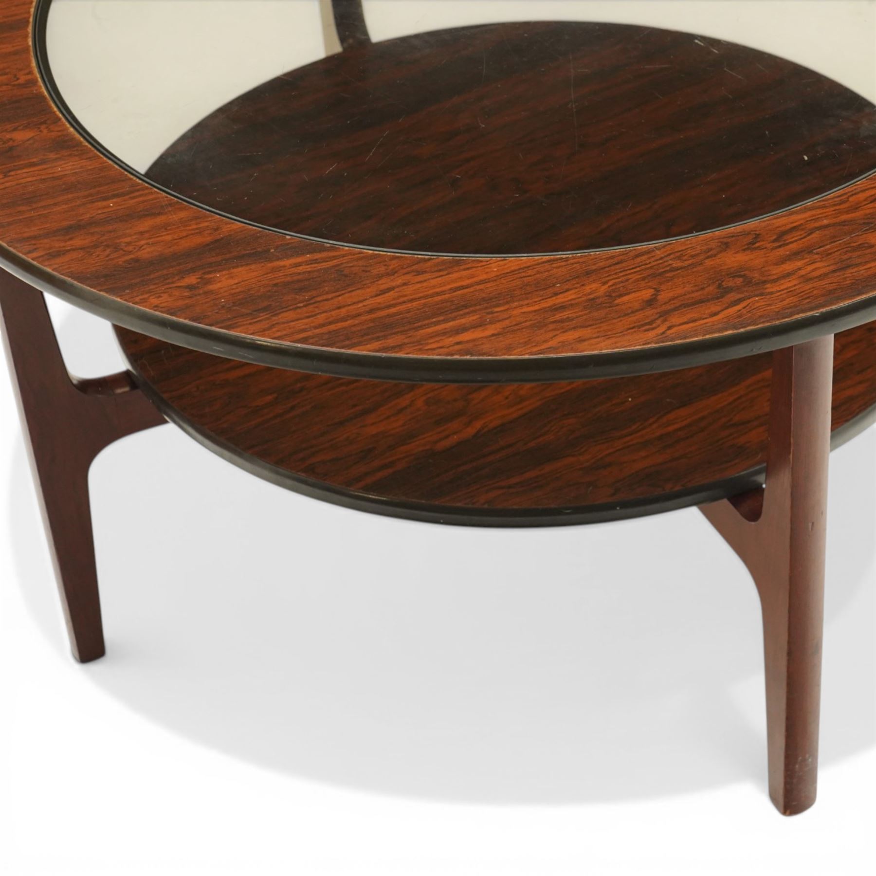 Mid 20th century Greaves & Thomas simulated rosewood circular coffee table, inset glass top with circular undertier on four tapering legs