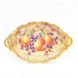 Late 20th century Royal Worcester dish, of oval form with gilt shaped rim and twin shell handles, hand painted by Jason Bowman with still life of fruit upon mossy ground, signed J Bowman, wit marks beneath, with makers fitted card box


