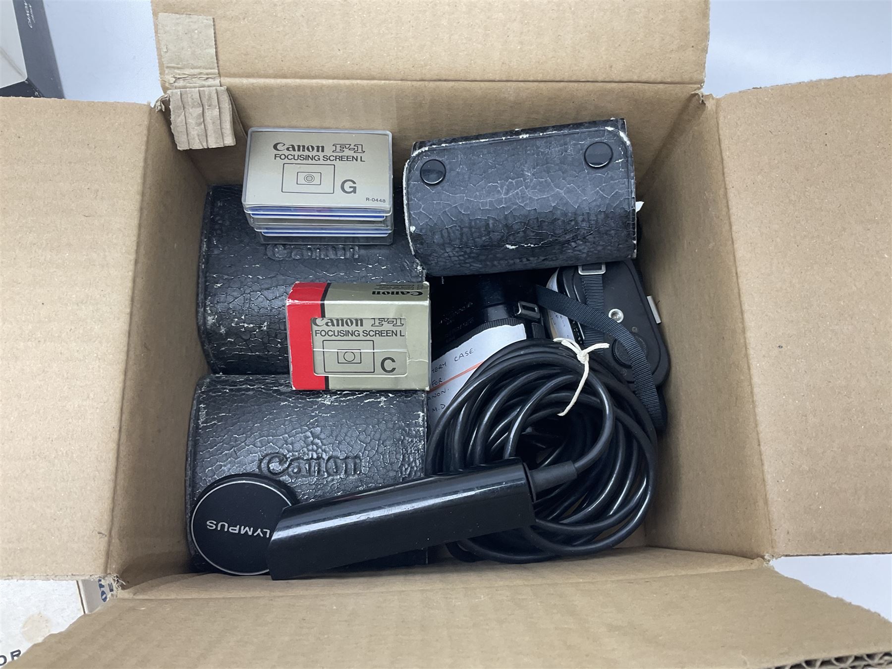 Collection of Canon lenses, to include 'Canon Lens FD 100mm 1:2.8', serial no 12821, 'Canon Lens FD 200mm 1:4' serial no 245313, 'Macro Canon Lens FL 50mm 1:3.5', serial no. 25505, 'Canon Lens FD 135mm 1:3.5 etc, together with other Canon equipment, including Bellows FL, Slide Duplicator etc 