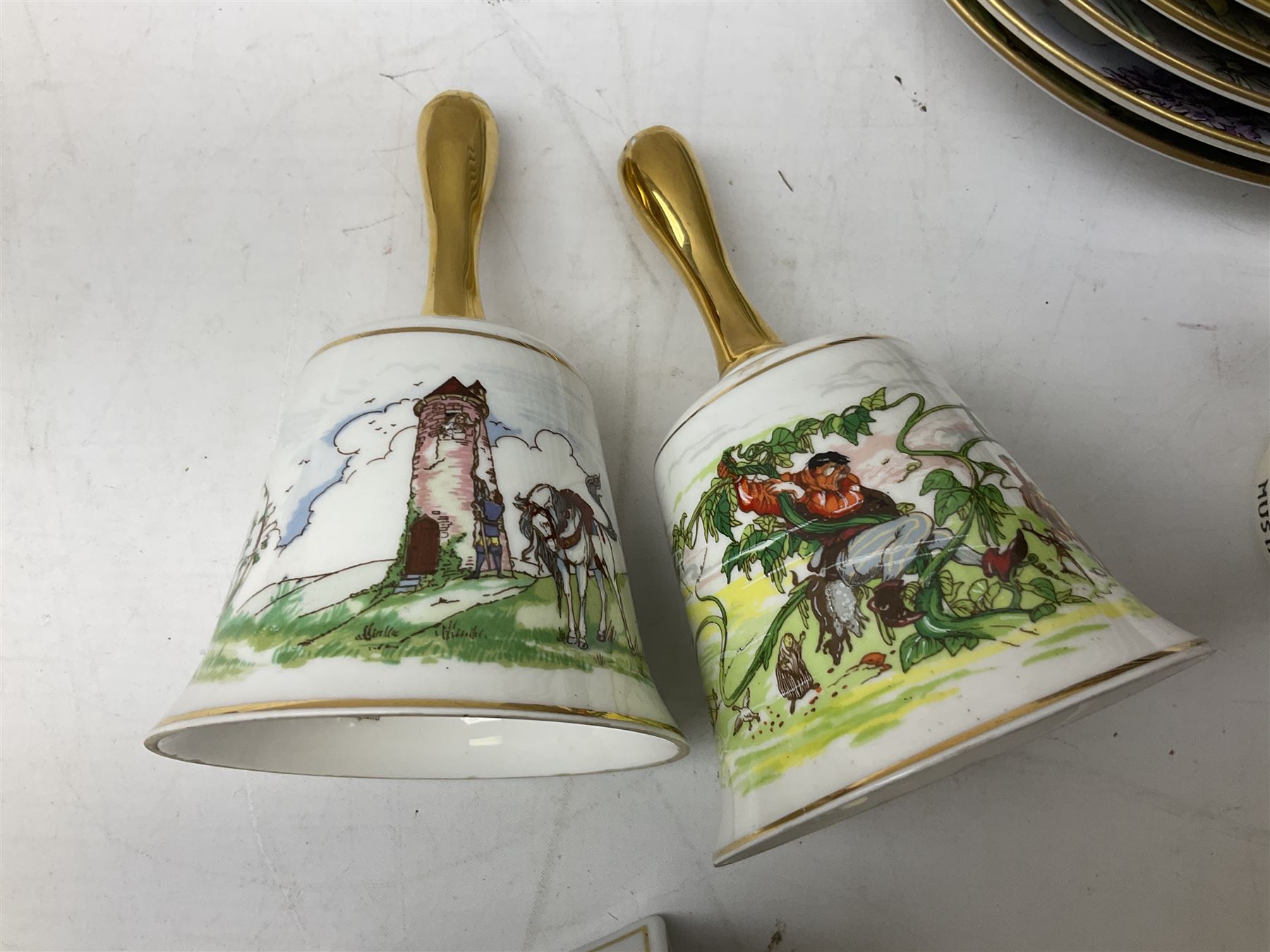 Royal Worcester Flower Fairies oval collectors plates, Goebel mustard pot, two Danbury Mint Fairy Tale bells, and pair of Hutschenreuther candlesticks decorated with scenes of Puss in Boots