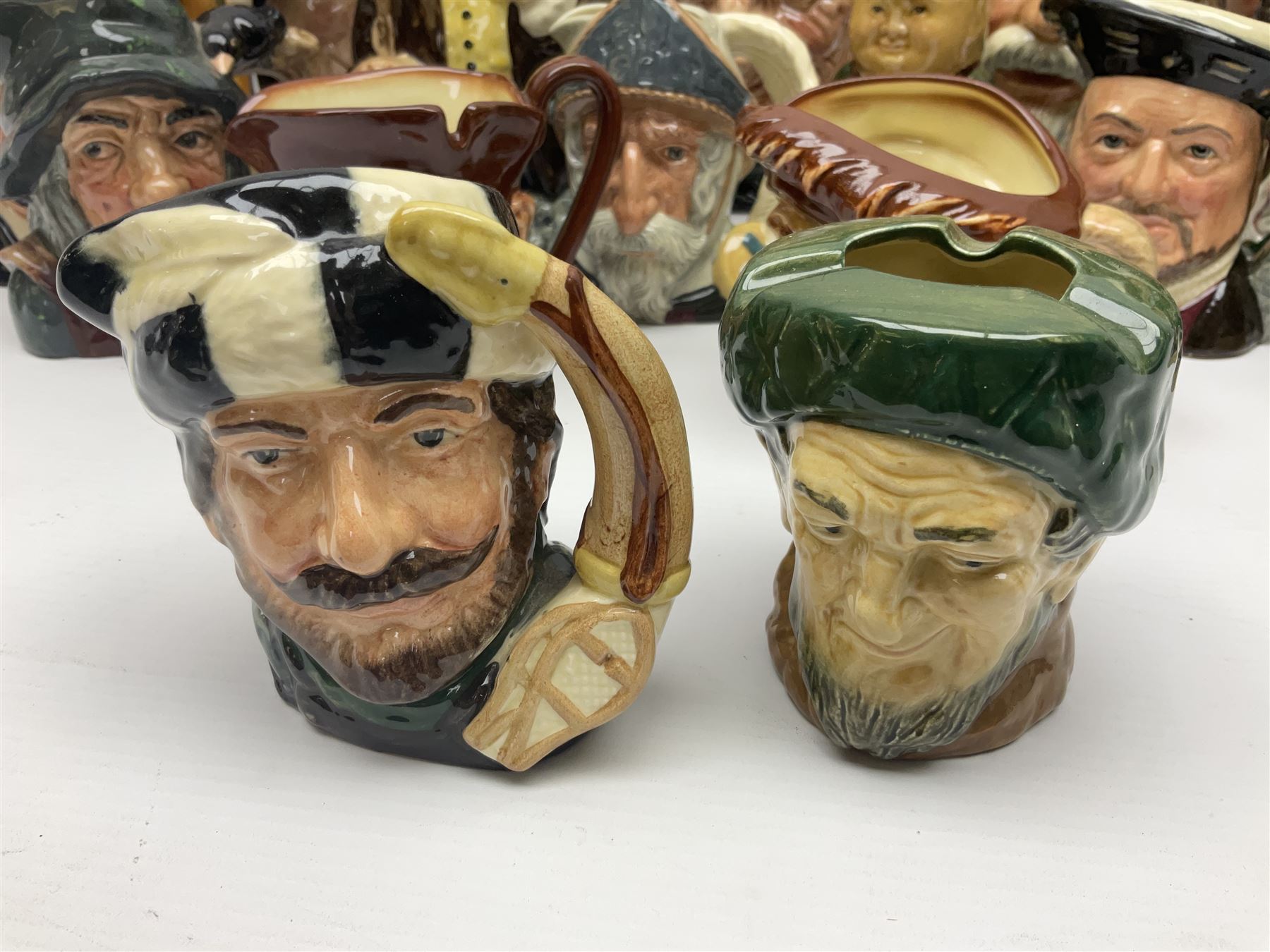 Large collection of Royal Doulton character jugs, to include Robinson Crusoe D6532, Tam O Shanter D6632, The Falconer D6533 etc, together with similar charater jugs and toby jugs   