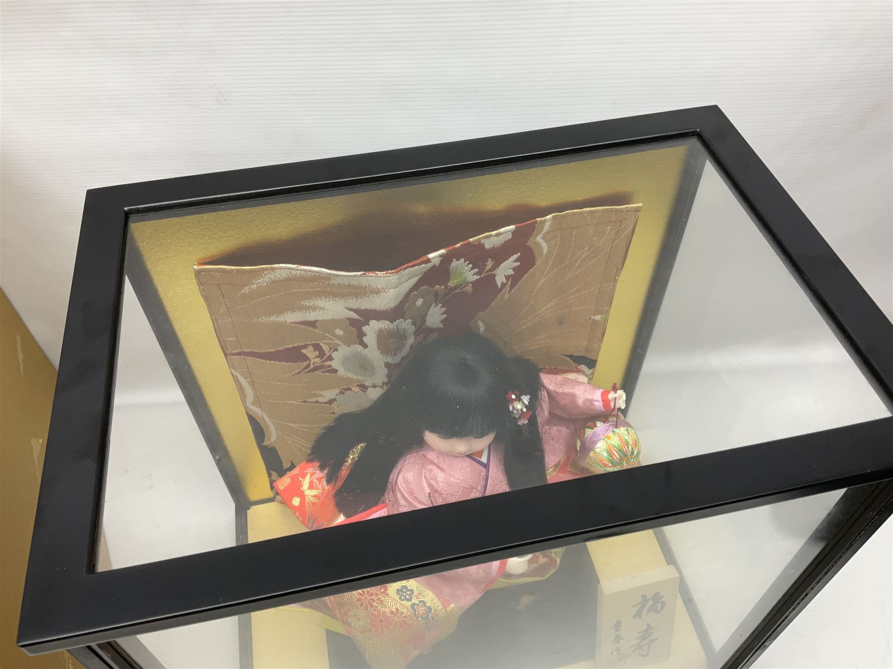 Japanese doll, dressed in traditional Japanese dress, within wooden glazed box, box H40cm