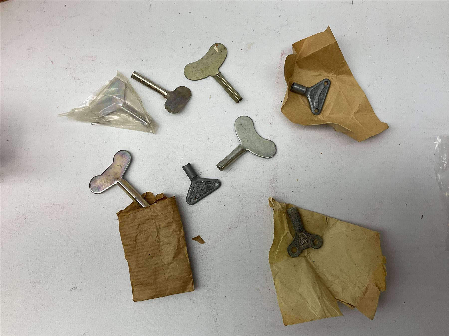 Seven modern Chinese, Japanese and Continental boxed tin-plate toys including Ucan Daire Flying Saucer, Drumming Animal, Circus Clown, Puzzle Cat, Bird with Jumping Action etc; and a quantity of clockwork toy keys (7)