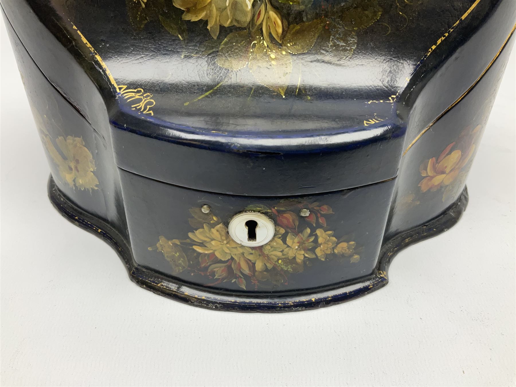 Victorian papier-mâché stationary box, of rounded wedge form with mother of pearl escutcheon, the hinged and curved cover and sides hand painted with floral sprays, opening to reveal a lined and fitted interior, H15cm L22cm D16cm