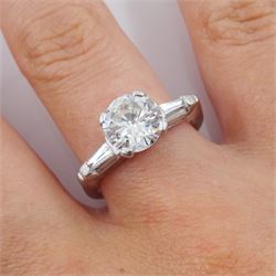 Platinum round brilliant cut single stone diamond ring, with tapered baguette diamond shoulders, central round diamond approx 1.70 carat