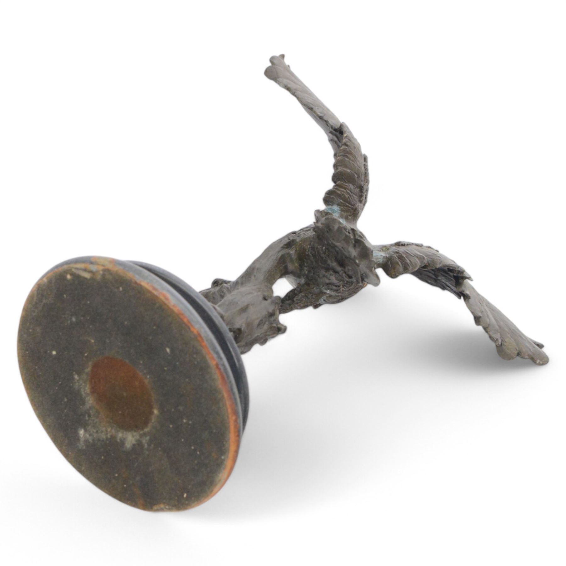 Bronzed figure of an owl taking flight, upon a circular hardstone base, H29cm