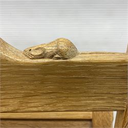 Mouseman - oak magazine rack, the top rail pierced with handle and carved with mouse signature, octagonal supports with two panelled and splayed sides, on sledge feet, by the workshop of Robert Thompson, Kilburn 