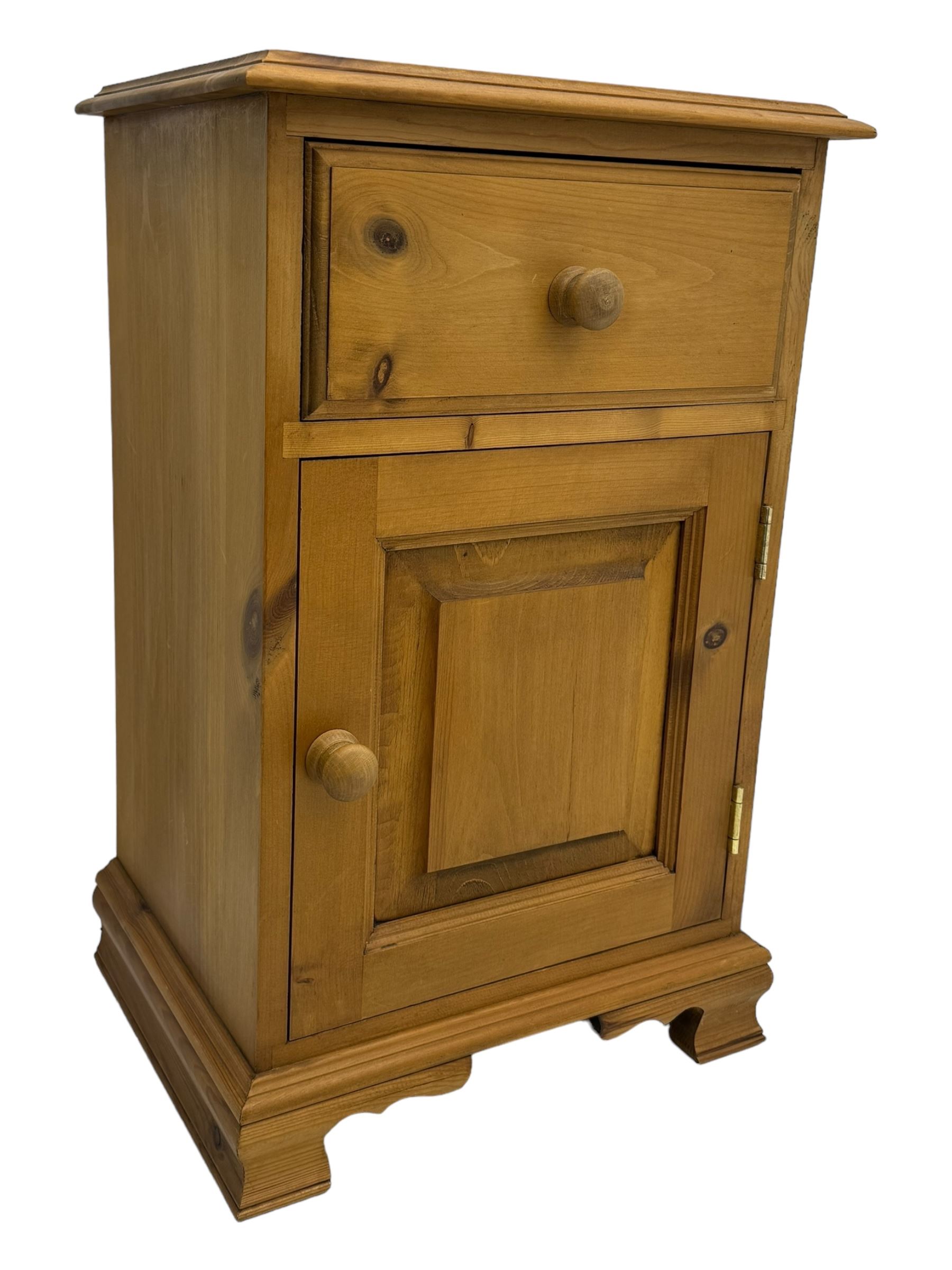 Pine chest of drawers topped with carved pediment with acorn and oak leaf motif, fitted with two short over three long drawers, standing on shaped apron base (W92, D46, H97cm); pine bedside cabinet, single drawer above paneled cupboard door enclosing open storage, shaped plinth base (W43, L32, H67cm)