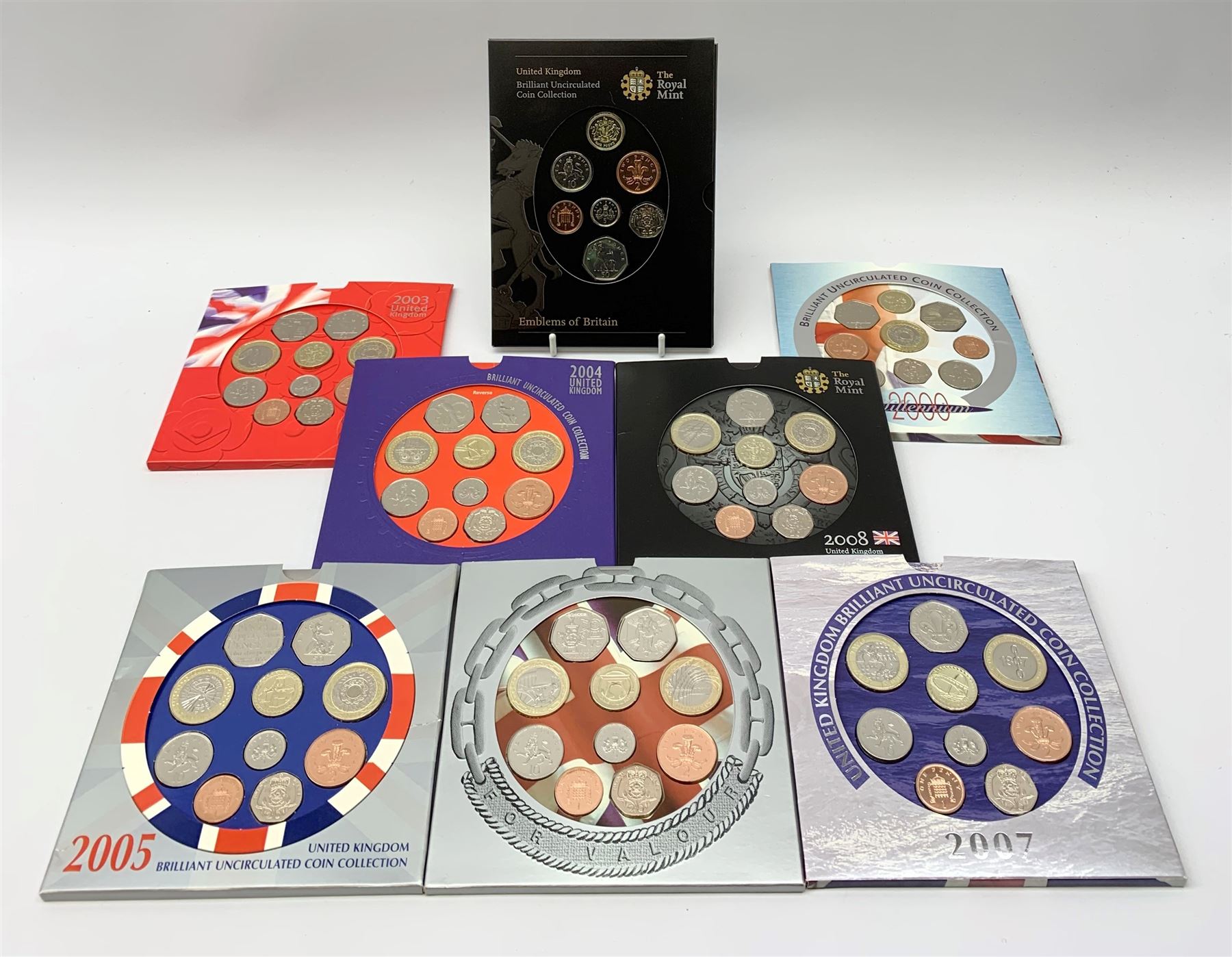Seven United Kingdom brilliant uncirculated coin collection, 2000, 2003, 2004, 2005, 2006, 2007 and 2008 and a 2008 'Emblems of Britain brilliant uncirculated coin collection, all housed in card folders (8)