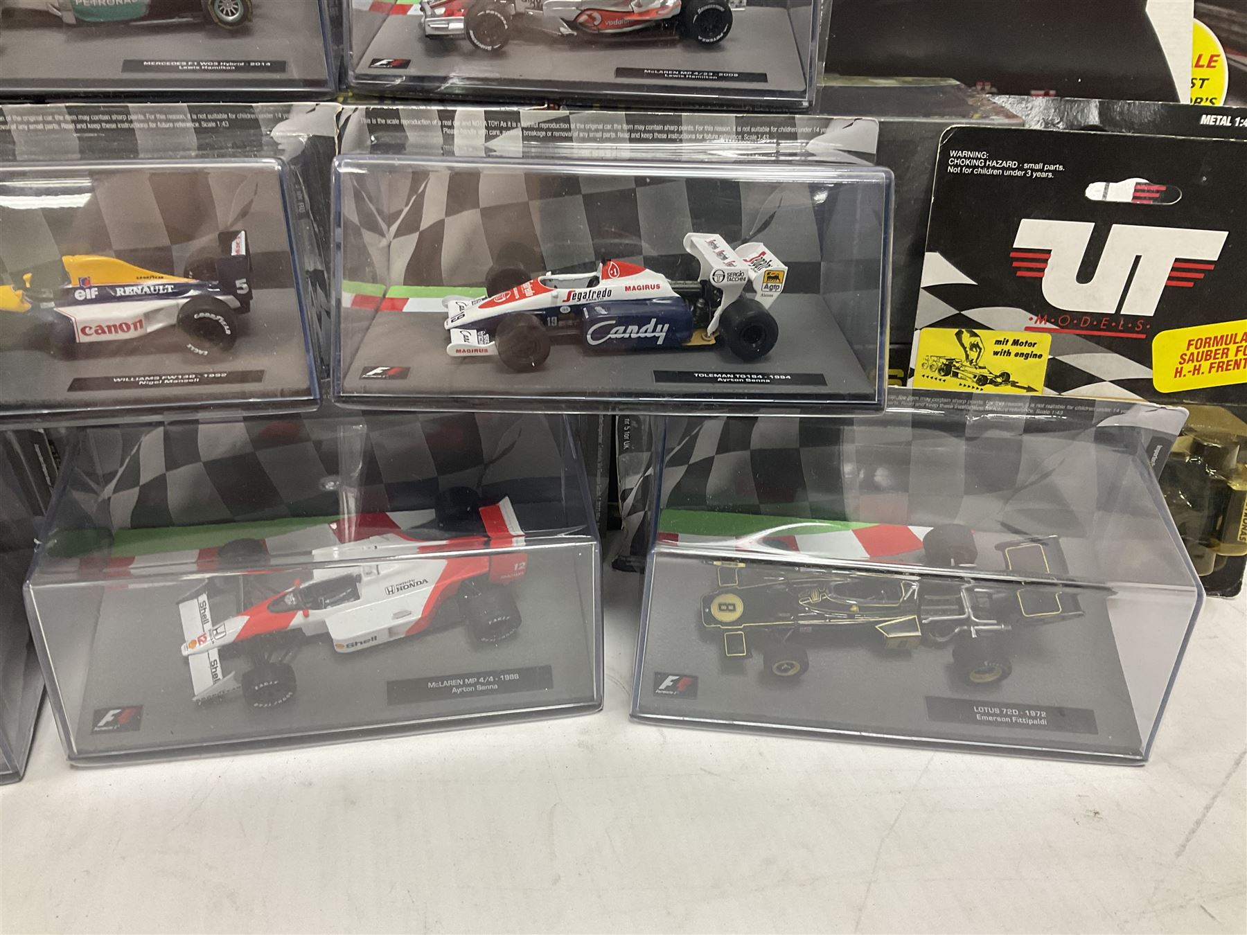Panini Formula 1 The Car Collection - twelve blister packed racing cars and quantity of periodicals; nine mostly unopened Atlas Editions British Touring Car Champions; and six other boxed/blister packed die-cast models of racing cars