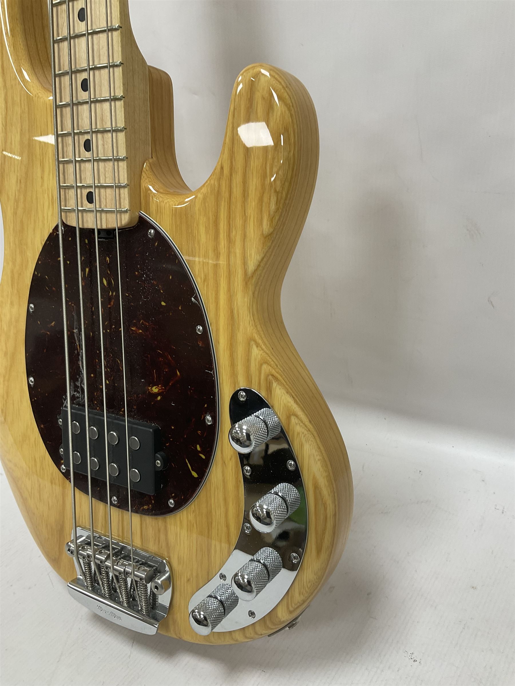 Ernie Ball Music Man Sting Ray 4 string bass guitar, in natural finish with roasted maple neck and tortoiseshell effect scratch guard, serial no 87485, in black Music Man hard case, guitar L114cm