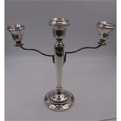 Modern silver mounted three branch candelabra, the tapering stem supporting a central candle holder and two removable curved branches with candle holders, upon spreading circular foot, hallmarked Birmingham 1968, maker's mark worn and indistinct, H25.5cm