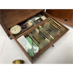 Brass binocular microscope, in a wooden carry case, with various attachments and slides 