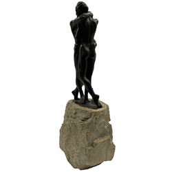 Composite sculpture embracing couple, after Joseph Bofill on a rocky base, height 33cm.