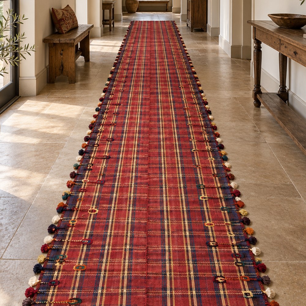 South West Persian Jajim kilim flatweave runner, composed of joined narrow woven bands,  field decorated with checked and striped motifs in shades of madder red, indigo, ivory ochre, and green, sides applied knotted wool tufts and braided elements with tasselled edges, (due to the large size, the runner is illustrated in two sections) 