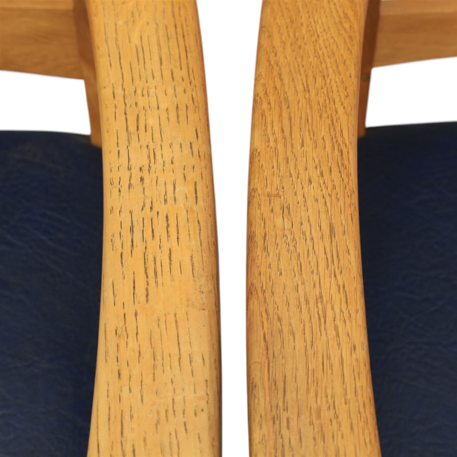 Modern twelve oak dining chairs including one 'Chairmans' chair, solid oak construction, slatted back and arm rests, blue leatherette padded seat, on tapered square supports 