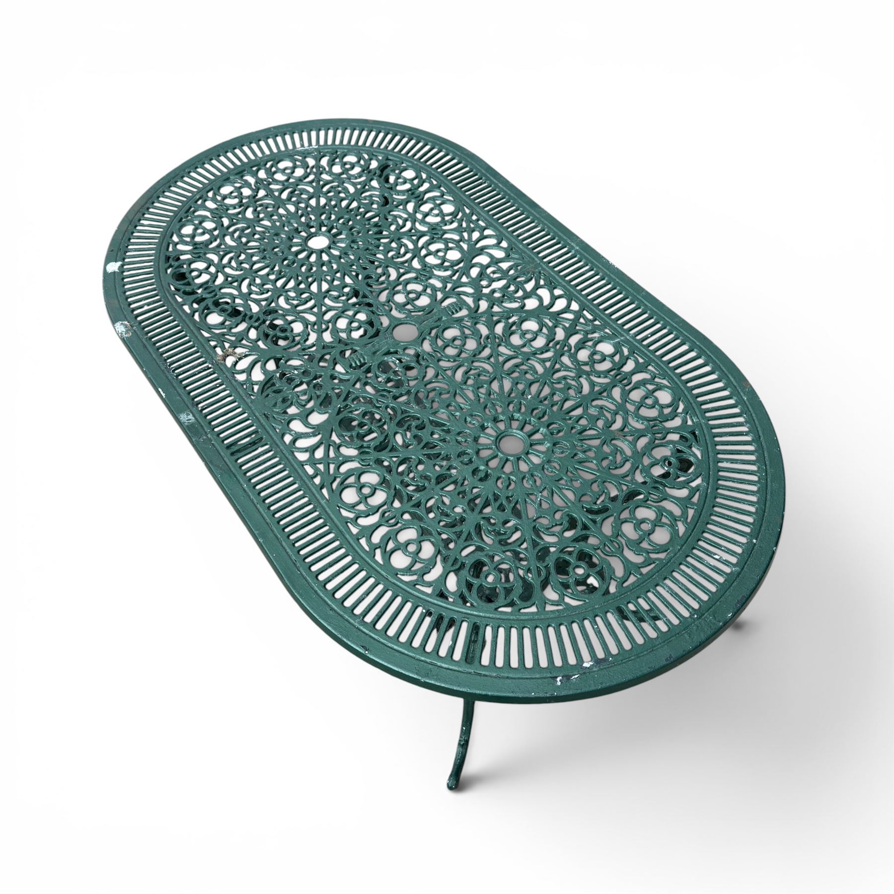 Cast aluminium oval garden table and set of four armchairs with pierced rose design back splats