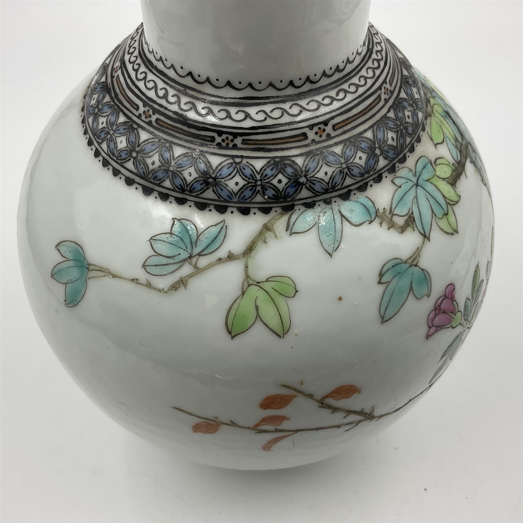 Pair of Chinese Republic porcelain vases, each painted in Famille Rose enamels with pairs of pigeons amidst peony, rock, flowering plants and leafy branches, possibly Qianlong seal beneath, H22cm 