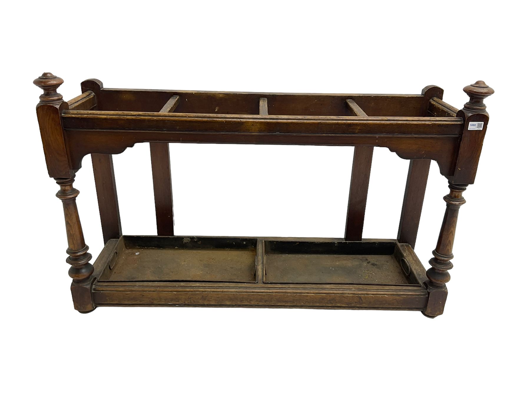 Edwardian oak hallway stick and umbrella stand, four divisions on turned supports, with metal tray liners and various sticks