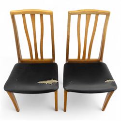 Sutcliffe of Todmorden - mid 20th century ‘S-Form’ teak dining table and chairs, the circular storable extending table with plain veneered top on tapered supports, together with matching dining chairs upholstered in black vinyl, with curved slat backs and shaped front supports, reflecting the sleek organic styling characteristic of 1960s British modern furniture design (Chairs H 93cm, W 46cm, D 46cm) (Extended 168cm)