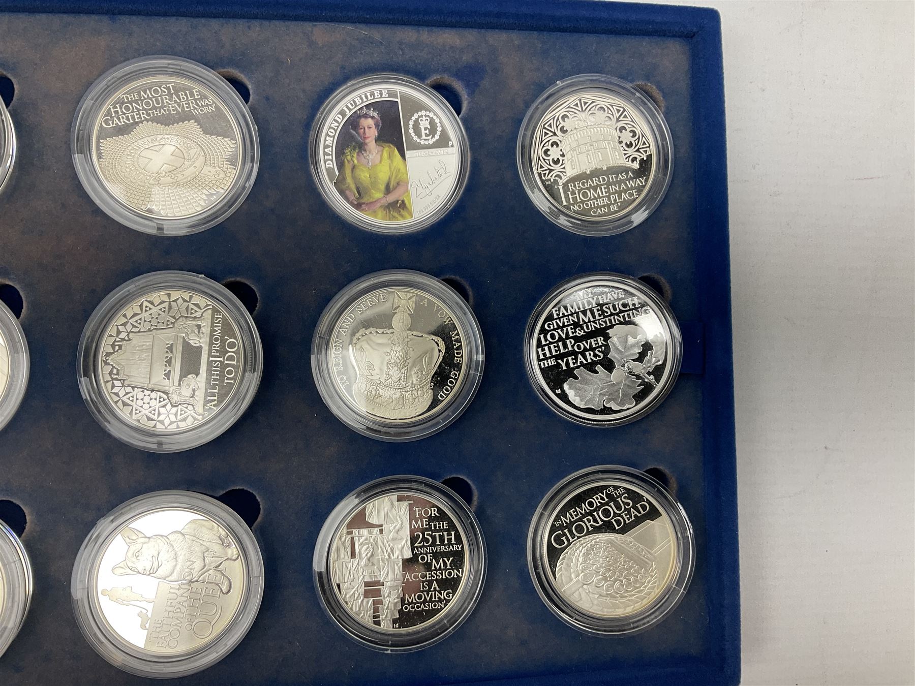 The Queen's Diamond Jubilee silver proof coin collection, consisting of twenty-four coins from Commonwealth countries, produced by The Royal Mint, housed in a blue presentation case, with certificate stating this is number 1397 of 15000 produced