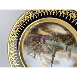 19th century French cabinet plate, hand painted with a central panel depicting dockside scene with boats and conversing figures, with ships and buildings in the background, within a dark blue gilt detailed border, D23cm