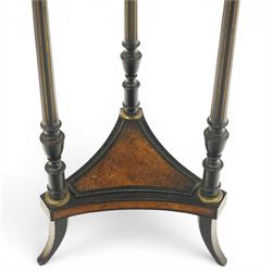 Late Victorian Aesthetic Movement ebonised and figured walnut occasional table, the circular burr top with boxwood strung and ebonised edge, surrounded by gilt metal egg-and-dart moulding, raised on three turned and fluted pedestals with parcel-gilt decoration, united by a triform undertier raised on splayed feet