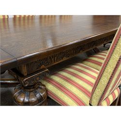 Royal Oak Furniture Co - Jacobean style oak dining table, rectangular top with a lunette carved frieze, acanthus carved baluster cup and cover supports joined by angular stretchers (276cm x 122cm, H81cm), and set ten (8+2) oak framed high back dining chairs upholstered in striped fabric with studded detail, turned supports and stretchers