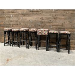 Seven tall bar stools with upholstered seat