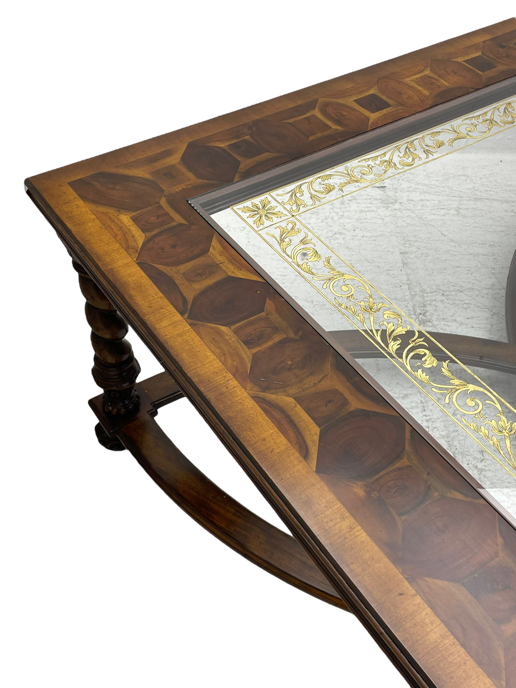 Jonathan Charles - large mahogany coffee table, the square oyster veneered top with verre églomisé inset, the glass hand-painted with gilt scrolling foliate patterns, raised on spiral turned supports with acanthus and gadroon carvings, united by interlocking demi-lune stretchers, on scrolled acanthus feet