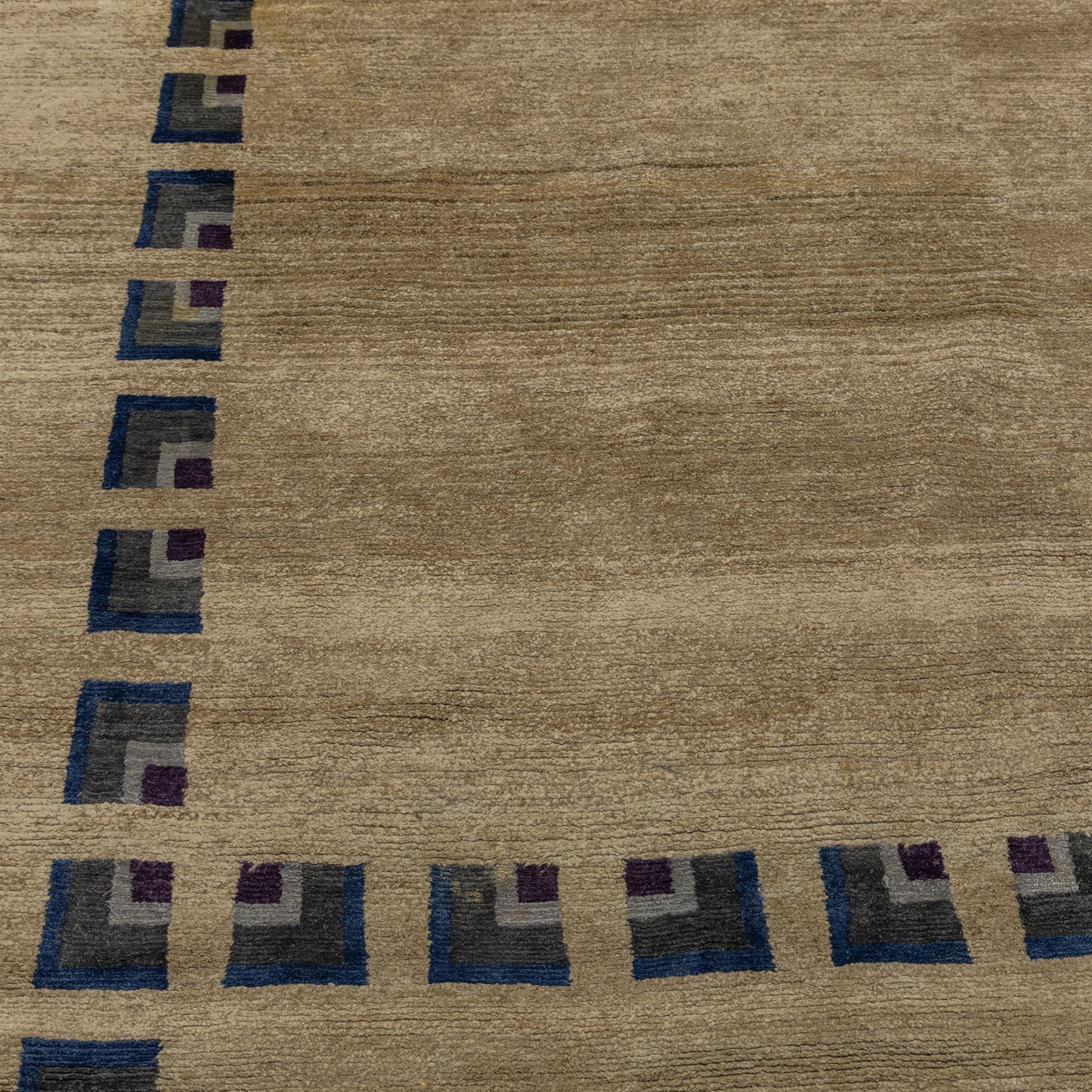 Rugs by Design - ‘Silk Stone’ Nepalese thick pile wool rug, with plain textured camel ground and geometric border detail in blue, grey and dark tones to all four sides