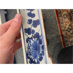 Chinese blue and white planter and stand, each of square slightly tapering and flared form, the planter decorated with two dragons and blossoming peonies, between stylised borders, the stand decorated with flower heads and vines, planter H30cm W29cm, stand H7cm D28.5cm